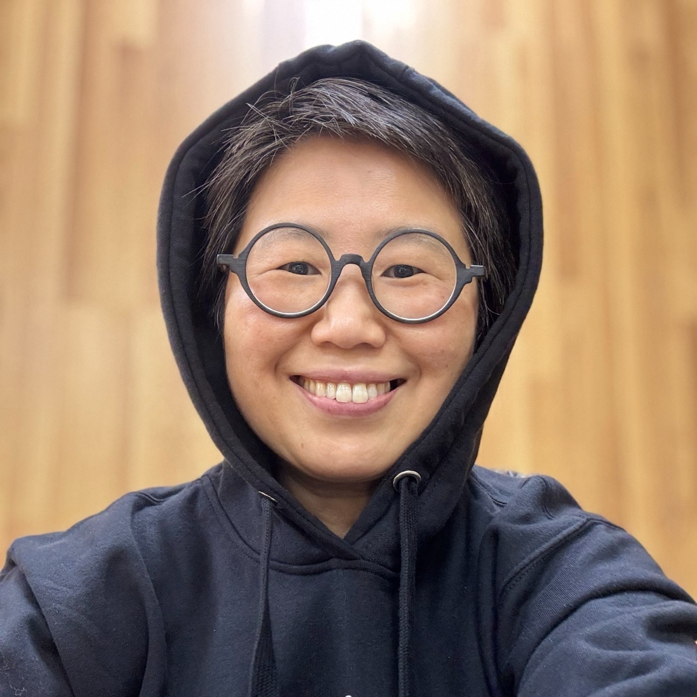Portrait of Bama Kim in a hooded sweatshirt