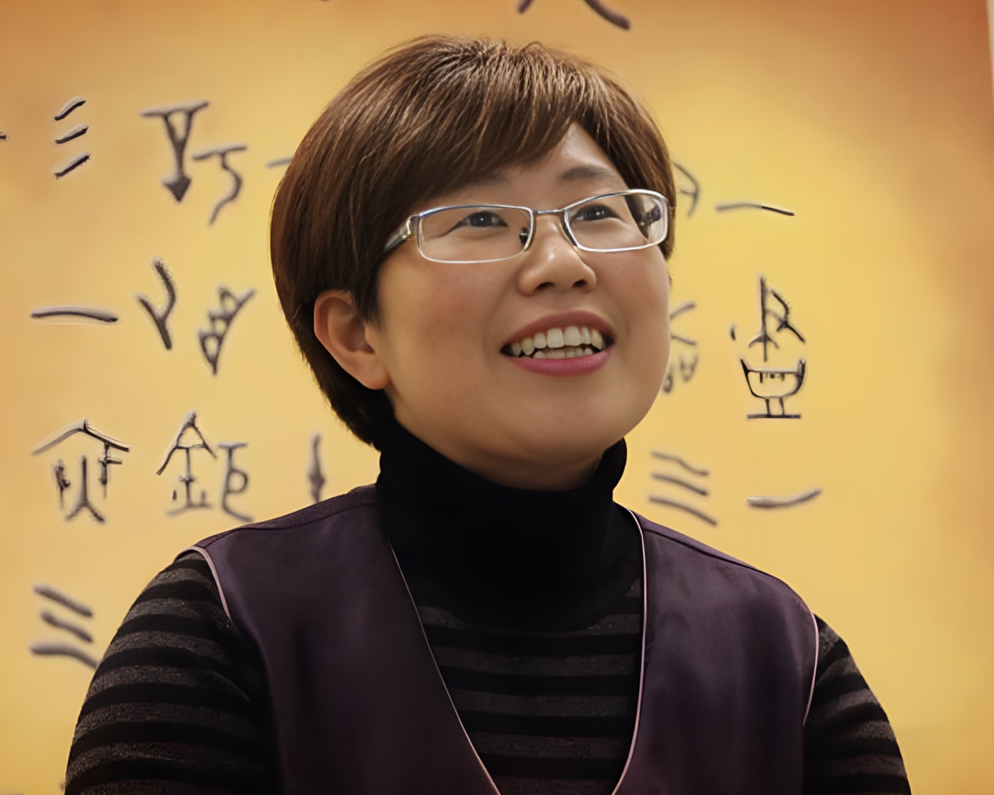 Bama Kim in front of a wall of Korean calligraphy